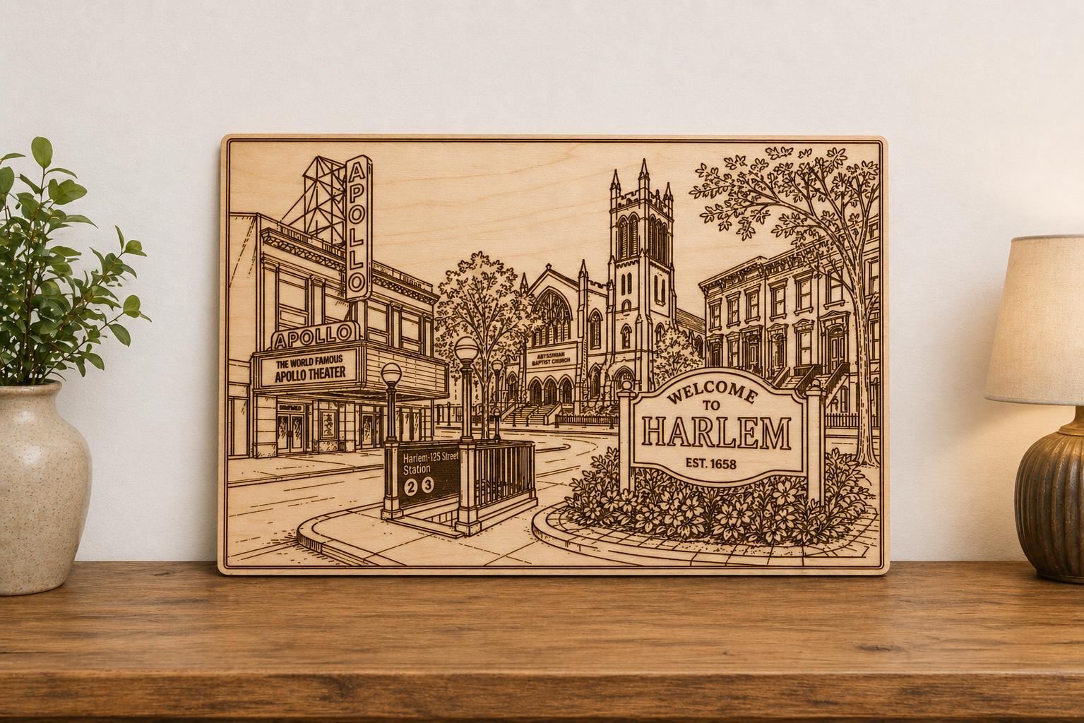 Large engraved Harlem street-scene plaque staged on a wood console between a plant and table lamp.